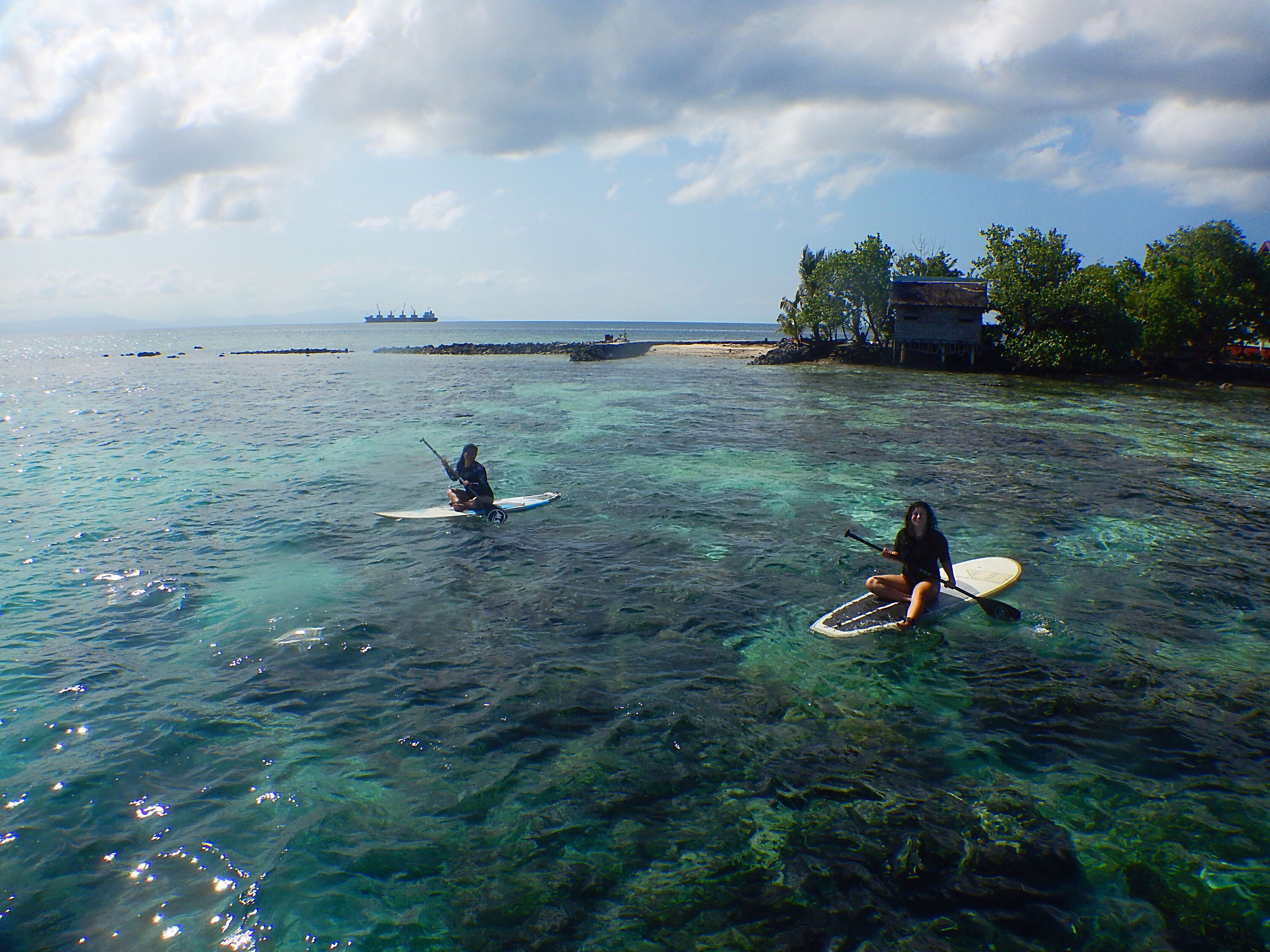 My friend, Claire Igawa and I paddle boarding on the coral reefs found in Gizo, Solomon Islands.