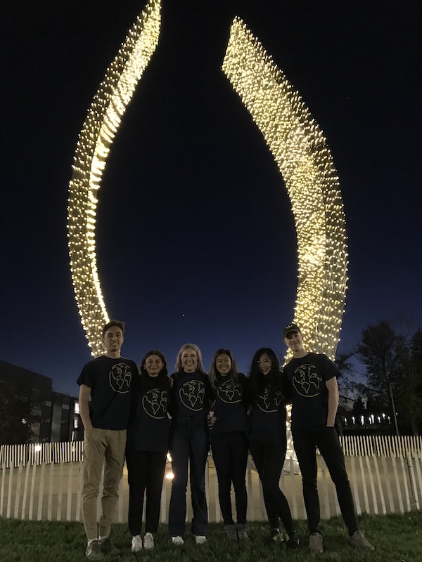 Fall 2019 exchange student cohort in front of the Beginnings Sculpture before the winter holidays