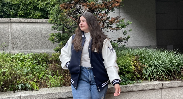 Ashley showing her school spirit in a letterman jacket